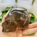 Factory Outlet Wholesale Hot Selling Crystal Skulls Hand Carved Smoky Quartz with Gold Rutilated Quartz Skulls for Fengshui