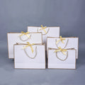 Luxury Custom Logo White Cardboard Shopping Paper Bag for Clothing Dress Shoes Paper Bag with Ribbon Bow