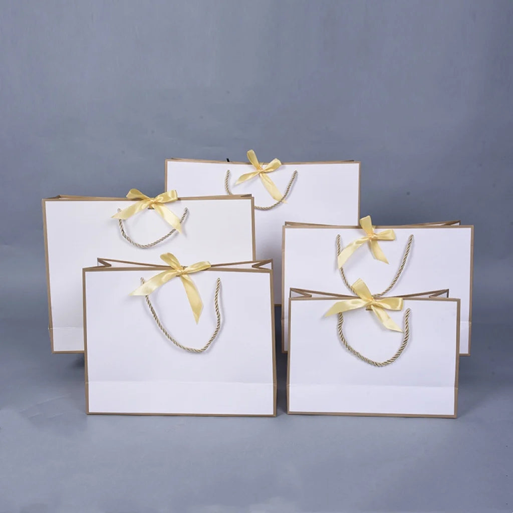 Luxury Custom Logo White Cardboard Shopping Paper Bag for Clothing Dress Shoes Paper Bag with Ribbon Bow