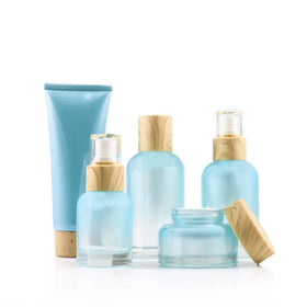 Wholesale High-grade Luxurious Blue Glass Cosmetic Bottle and Jar with Bamboo Caps 120ml 100ml 40ml 50g Cosmetic Container Pack