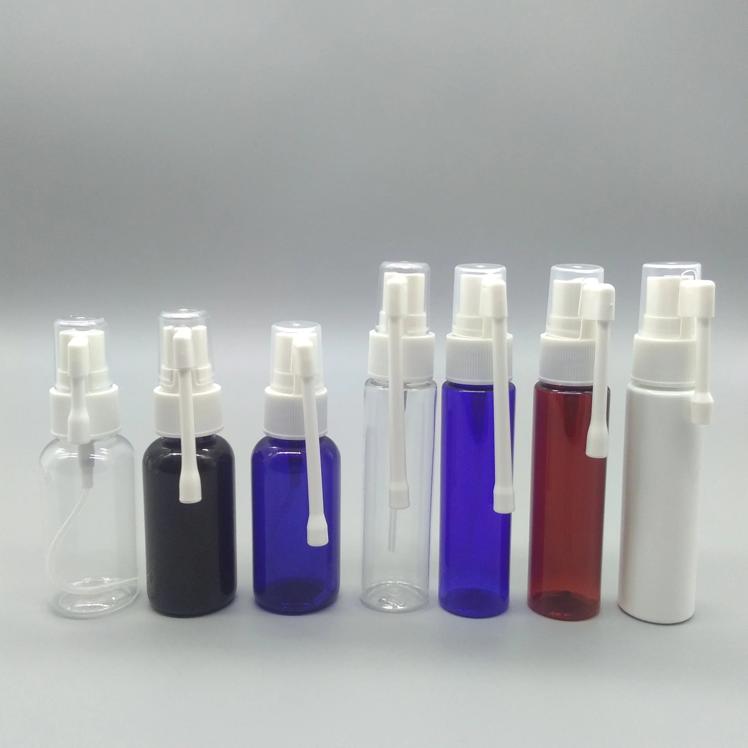 Pink Blue White 40ml Round Shape PET Plastic Liquid Oral Spray Bottle with Long Nozzle Dust Cap Personal Care Packaging 20/410