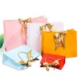 Custom Luxury Bowknot Ribbon Printed Kraft Paper Bag Foil Stamping Wedding Gift Jewelry Cosmetic Shopping Bag with Ribbon Logo