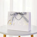 Customizable Eco-friendly Biodegradable Ivory Board Paper Gift Bag with Ribbon Handle for Supermarket Use