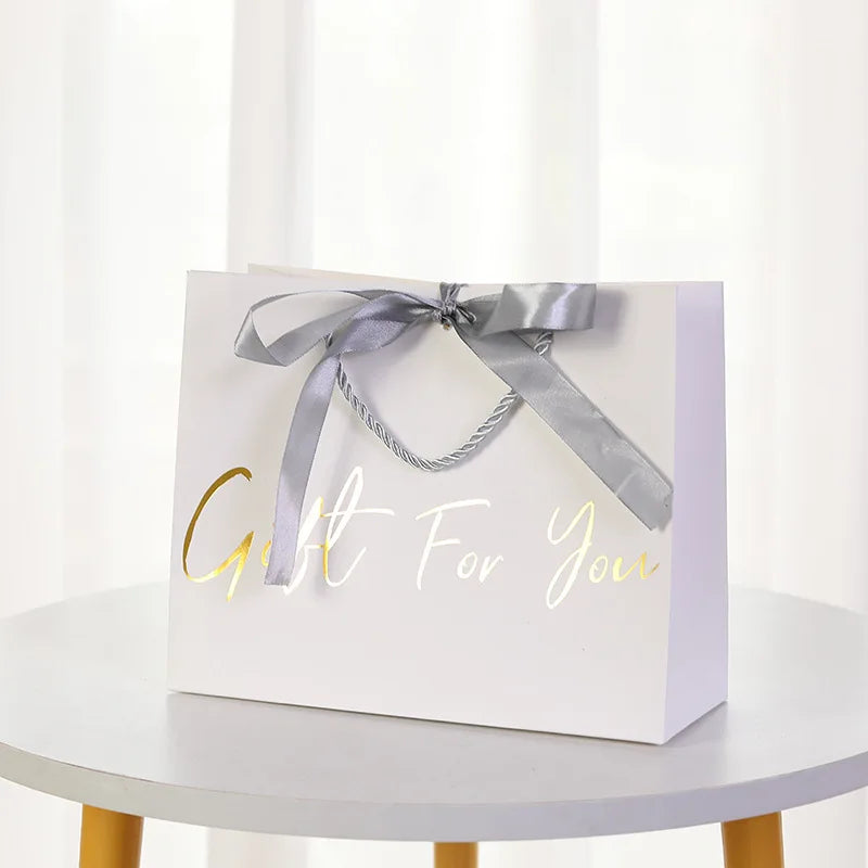 Customizable Eco-friendly Biodegradable Ivory Board Paper Gift Bag with Ribbon Handle for Supermarket Use