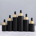 Top Grade 20ml 30ml 40ml 50ml 60ml 80ml 100ml Matte Black Glass Dropper Bottles with Bamboo Lid for Sale