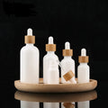 Luxury Empty Essential Oil Bottle Opal White Porcelain Glass Glossy Finish With Natural Bamboo Dropper