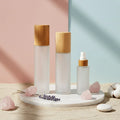 Factory Direct Bamboo Pump Bottles Customizable Refillable Frosted Glass Cosmetic Packaging for Bulk Orders