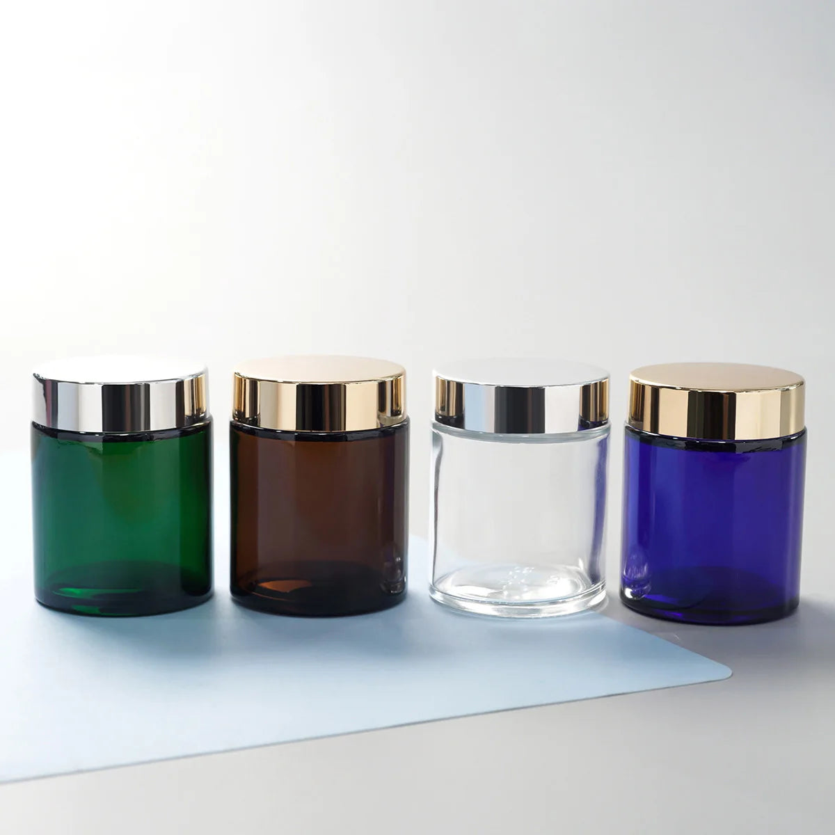 100g Cosmetic Mini Glass Jar  Containers with Lid Customized Colored and Round Shape
