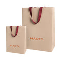 Luxury Recyclable Kraft Paper Bags Embossed Texture Custom Logo Ribbon Handles for Retail Shopping for Skin Care Shampoo