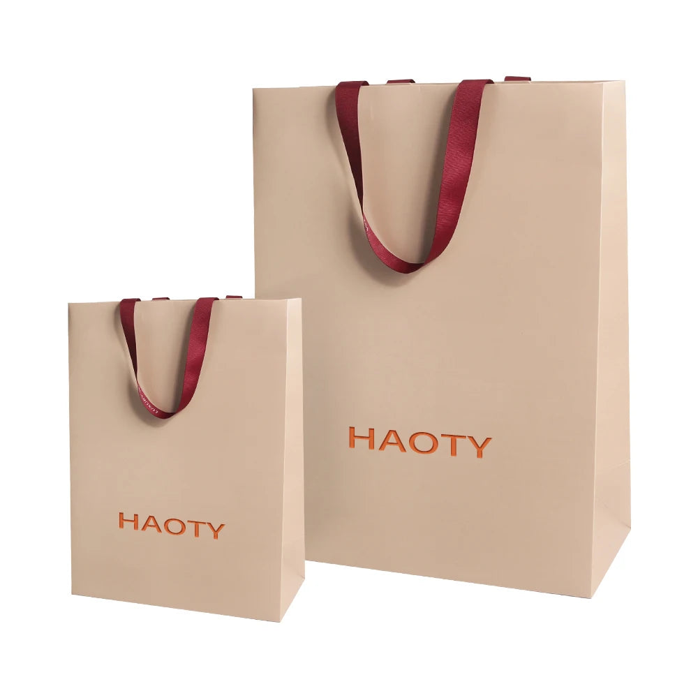 Luxury Recyclable Kraft Paper Bags Embossed Texture Custom Logo Ribbon Handles for Retail Shopping for Skin Care Shampoo