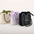 GLAMPKG Custom Logo Printed White Beige Cosmetic Gift Paper Bags Shopping Jewelry Packaging Paper Bag With Ribbon Rope Handle