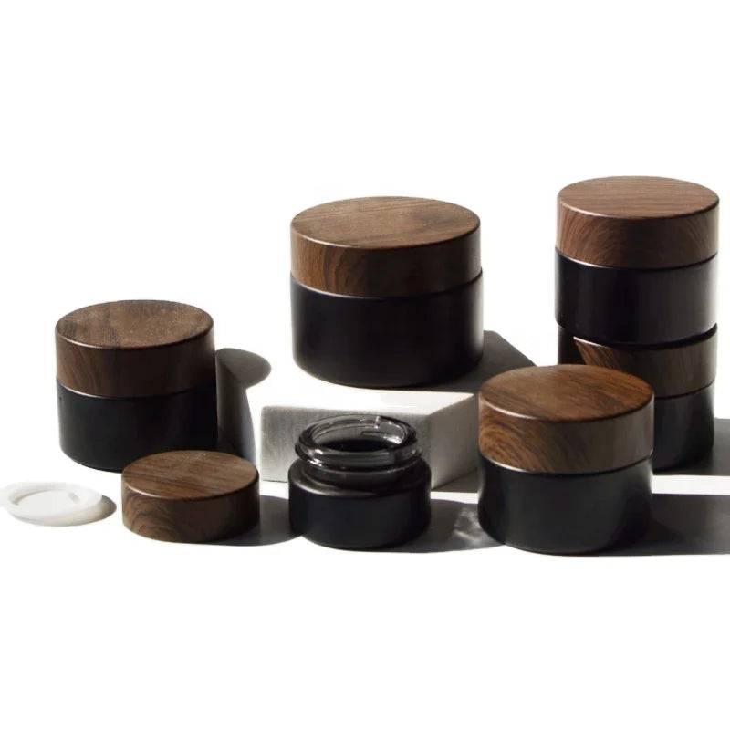 Hot Sale 5g 10g 15g 20g 30g 50g 100g Facial Care Cosmetic Packaging Matte Black Cosmetic Glass Cream Jar With Dark Wood Lid