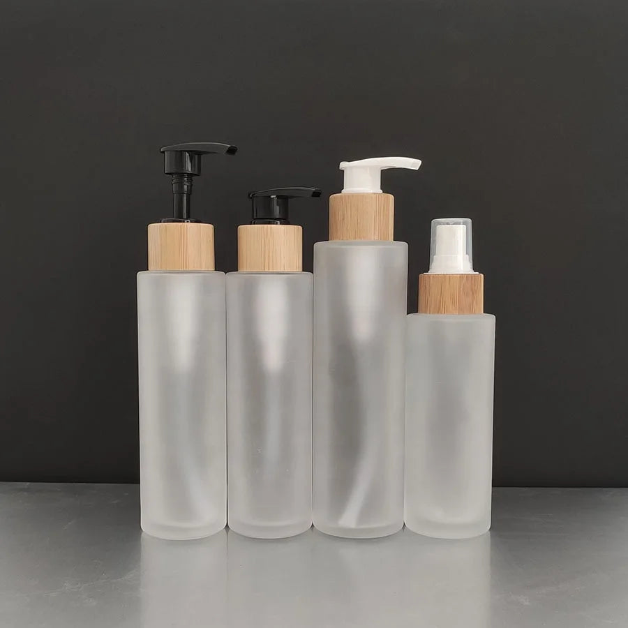 Low MOQ Luxury 60ml Bamboo Pump Lotion Spray Bottle 2oz Glass with Bamboo Lid for Face Cream & Skin Care