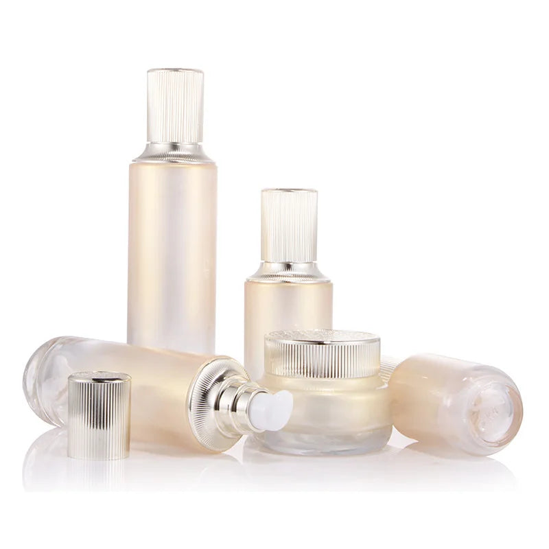 Wholesale Custom logo Luxury 50g 40ml 60ml 100ml and 120ml Grade Gold Cosmetic Glass Bottle and Jar with Gold Pump and clear Cap