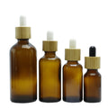 wholesale empty cosmetic amber glass body oil 15ml 20ml 30ml 50ml dropper bottle with bamboo cap
