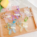 2023 New Laser Luminous Dog Key Chain Bag Pendant Color Key Chain Cartoon Bow Pearl Pendant