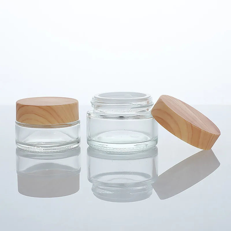 Wholesale Cosmetic Luxury 30g 50g clear Glass Cream Jar with Wood Grain Plastic Lid Face Cream Container 1 oz Eye Cream Pot