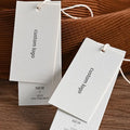 Luxury Custom Recyclable White Double Swing Hang Tag PVC Printed Textured Paper for Clothing Bags Shoes Hot Stamping Labels Toys