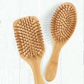 Wholesale Customizable Comfortable Natural Bamboo Portable Classic Hairbrush Wooden Paddle Hair Comb with Handle for Massage