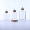 Luxury Cosmetic Packaging Square Glass Dropper Bottles 30ml 50ml 100ml Essential Oil Bottle with Bamboo Dropper