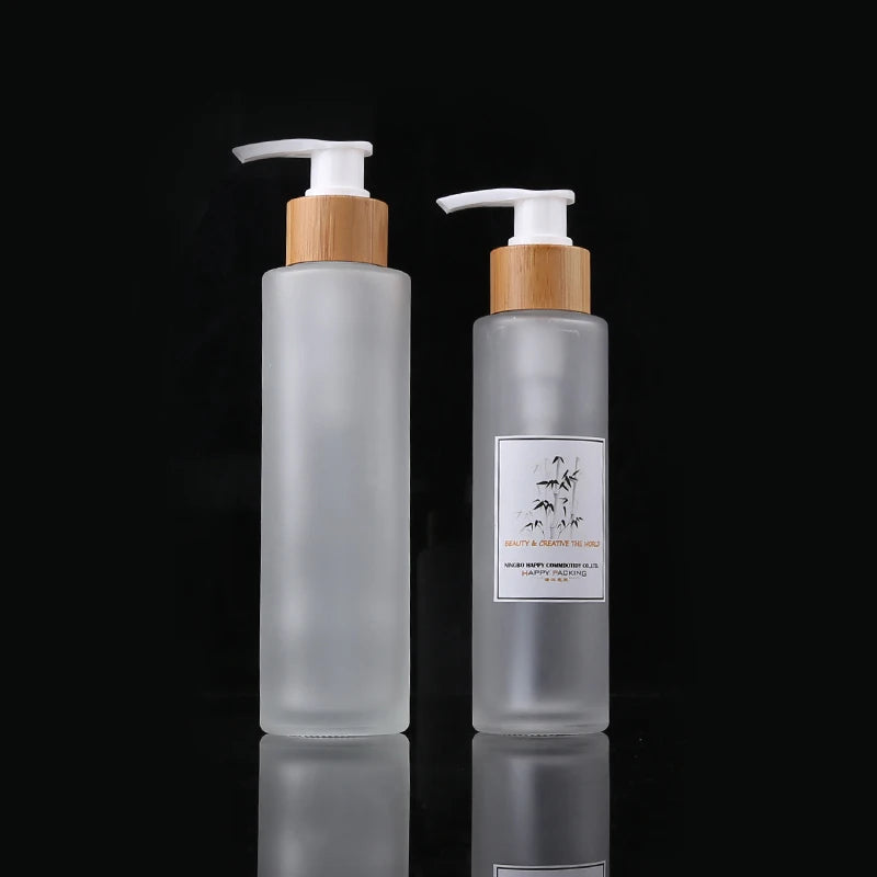 Natural Wholesale100ml Flat Shoulder Empty Cosmetic Packaging Glass Bottle Bamboo Lotion Pump Round Bottle with Bamboo Lid