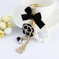 Wholesale New Creative Small Gift Pendant Perfume Bottle Bow Shape Alloy Keychain Pearl Pendant Keychain Flowers Metal